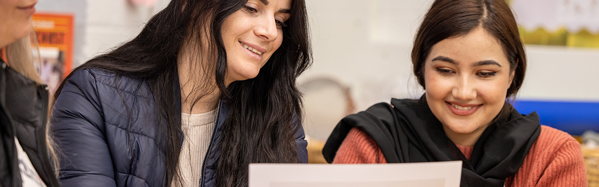 Two female Hayes students working on a class task - Uxbridge College